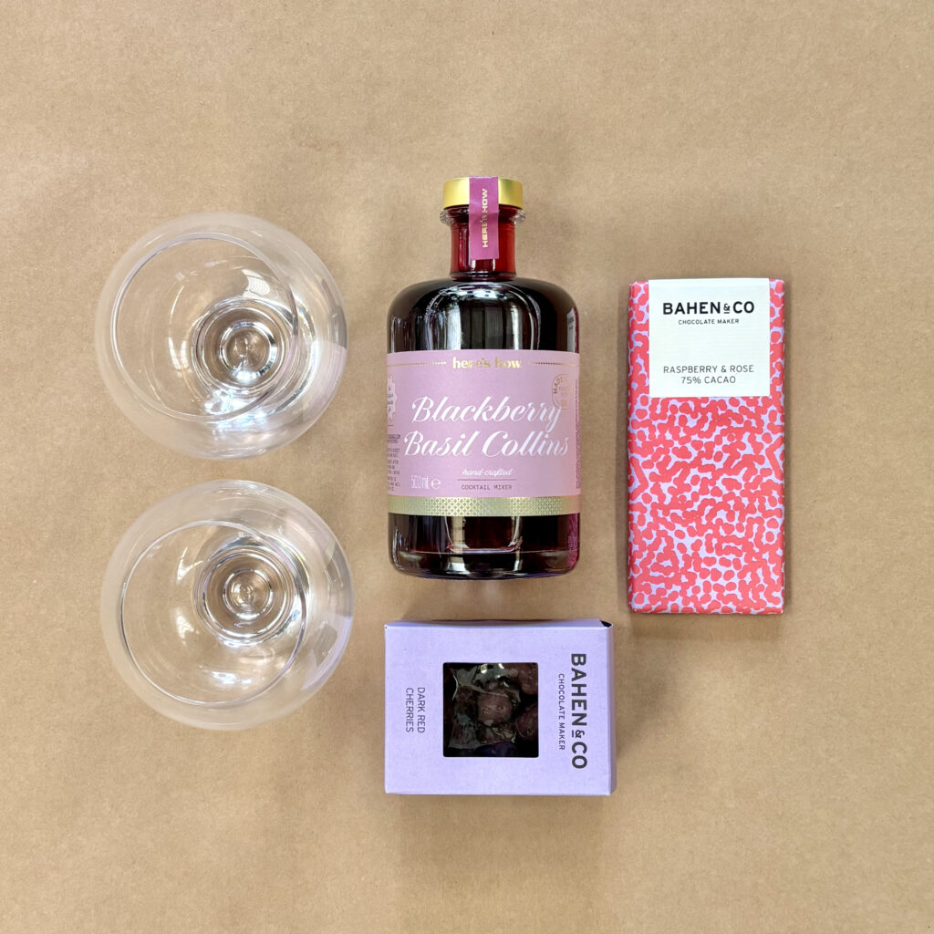 Berry Good Cocktail Hamper Berry themed gift hamper flat lay Bahen & Co Raspberry & Rose 75% Cacao bar Here's How Blackberry Collins Cocktail Mixer
